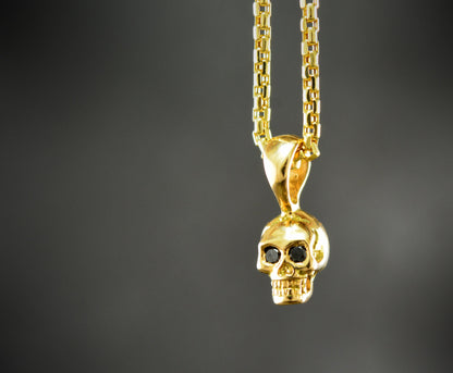 Colgante calavera diminuta en oro 10k, 14k y 18k  con piedras naturales - D´Cast